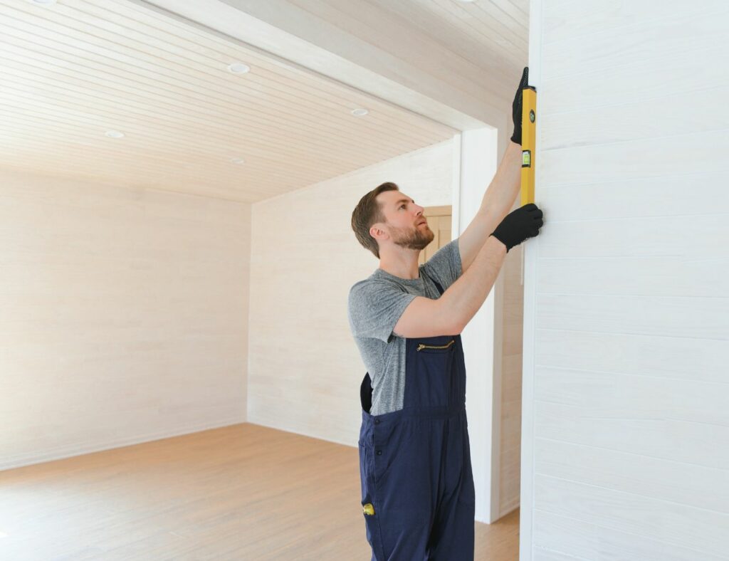 man measuring a wall